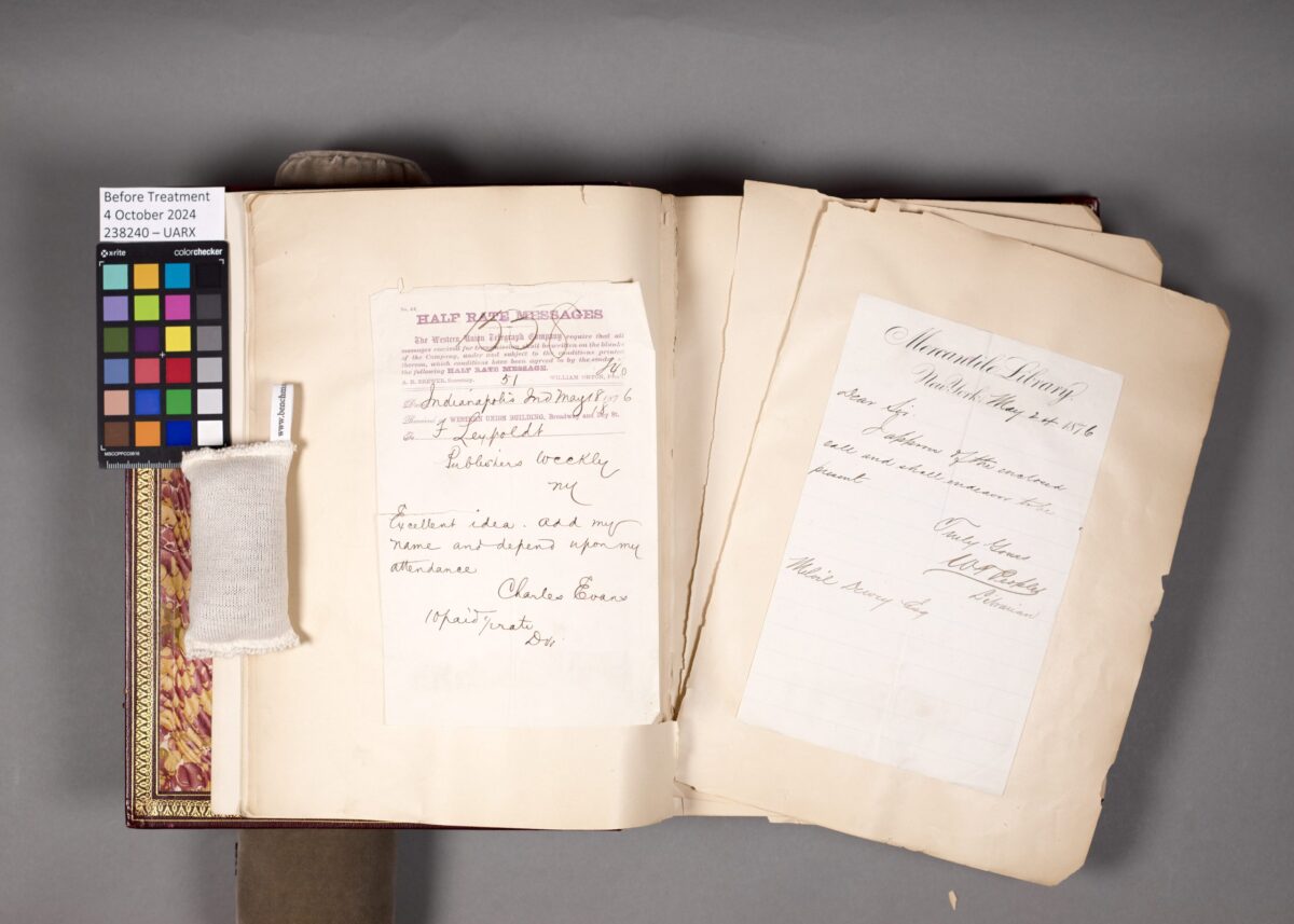 The 1876 library conference scrapbook in its original binding with detached pages.