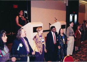 Speakers joining hands and singing “We Shall Overcome” at the Martin Luther King, Jr. Holiday Observation and Sunrise Celebration at the 2000 ALA Midwinter Meeting in San Antonio.