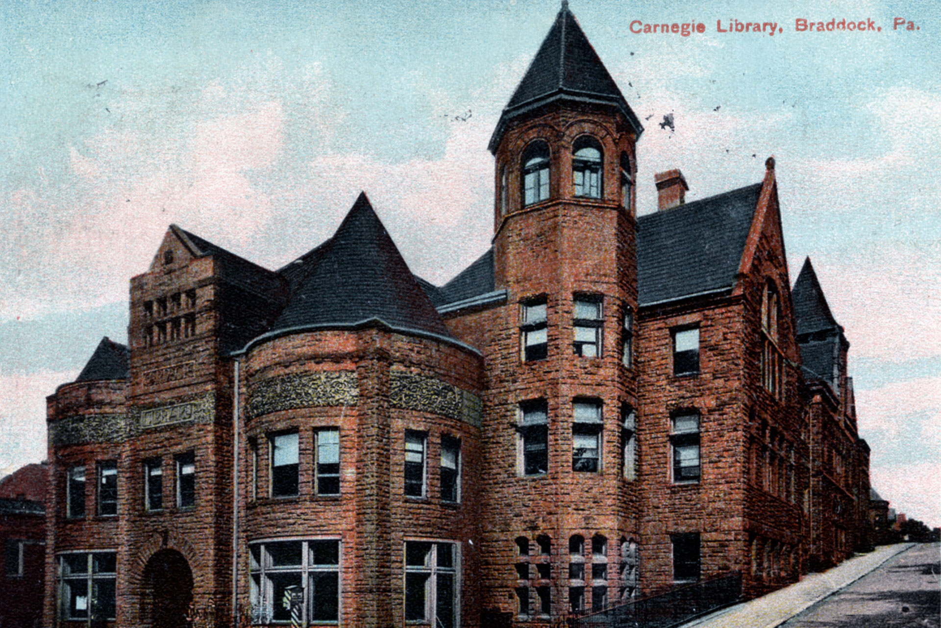 MAGE: Postcard featuring the first US Carnegie Library located in Braddock, Pennsylvania. The library continued operation until its doors closed in 1974 due to financial challenges and construction. However, the library reopened in 1983 and was designated as a National Landmark in 2012. The Braddock Carnegie Library celebrated its 130th Anniversary in 2019.