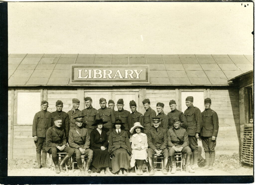 Servicemen and camp librarians, including Harriett Long, in front of a American Library Association camp library in Le Mans, France. 1918. From the ALA Archives.