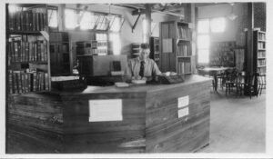 Librarian at the Reference Desk in Camp Johnston Library, from the ALA Archives.