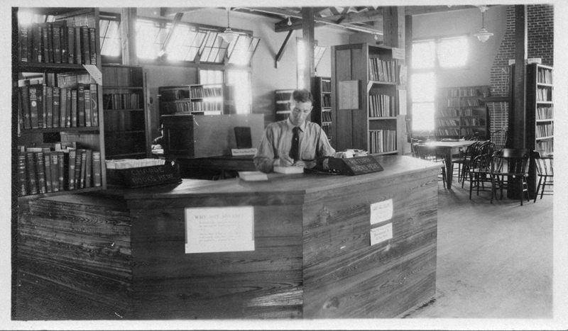 Librarian at the Reference Desk in Camp Johnston Library, from the ALA Archives.